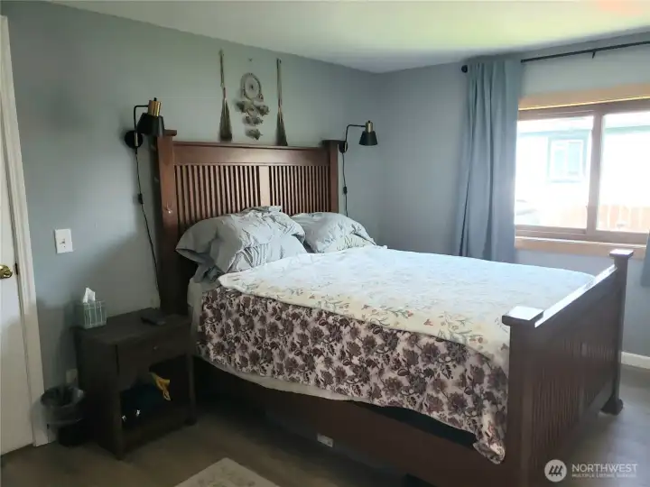 Another View of the A Huge Primary Master Bedroom Showing New Interior Paint, White Painted Trim and Vinyl Plank Flooring.