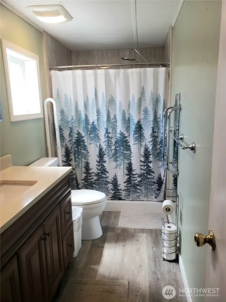 Another View of the Large Primary Master Bathroom with New Quartz Vanity, Sink, Toilet, Brand New Jacuzzi Walk In Shower, Interior Paint, Trim and Vinyl Plank Flooring.
