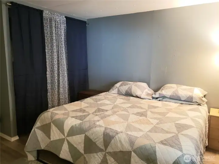 Another Picture of the Large Second Bedroom Showing New Interior Paint, White Painted Trim and Vinyl Plank Flooring.