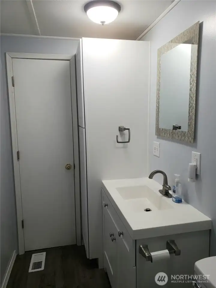 Nice Main Guest Bathroom with New Quartz Vanity, Sink, Faucet, Toilet, Interior Paint, White Painted Trim, Brand New Jacuzzi Tub and Shower Surround and Vinyl Plank Flooring.