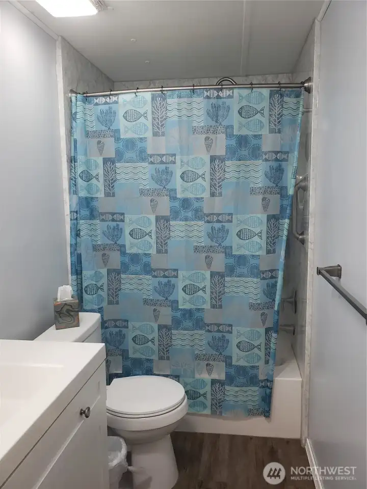 Nice Main Guest Bathroom with New Quartz Vanity, Sink, Faucet, Toilet, Interior Paint, White Painted Trim, Brand New Jacuzzi Tub and Shower Surround and Vinyl Plank Flooring.