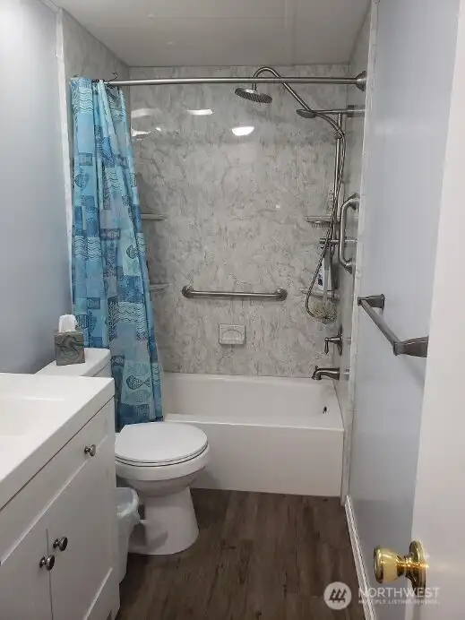 Another View of the Nice Main Guest Bathroom with New Quartz Vanity, Sink, Faucet, Toilet, Interior Paint, White Painted Trim, Brand New Jacuzzi Tub and Shower Surround and Vinyl Plank Flooring.