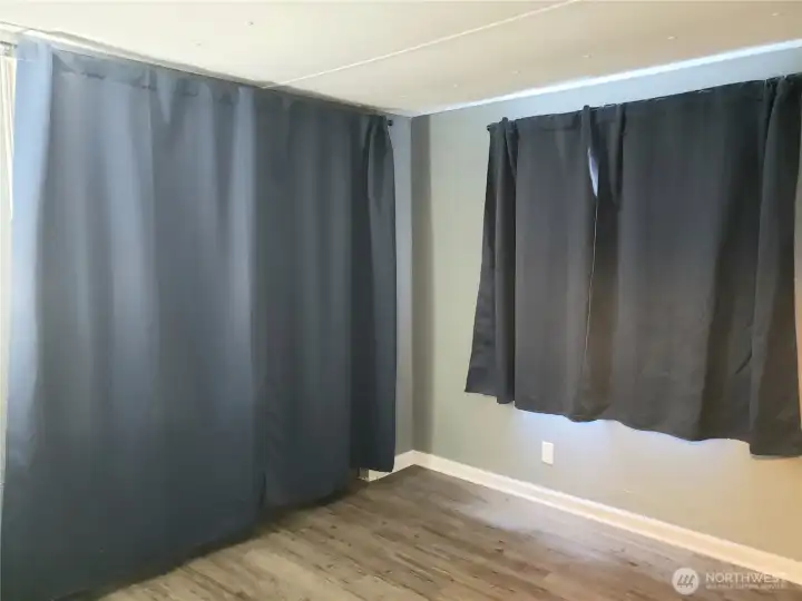 Another Picture of the Nice Size Third Bedroom Showing New Interior Paint, White Painted Trim and Vinyl Plank Flooring.