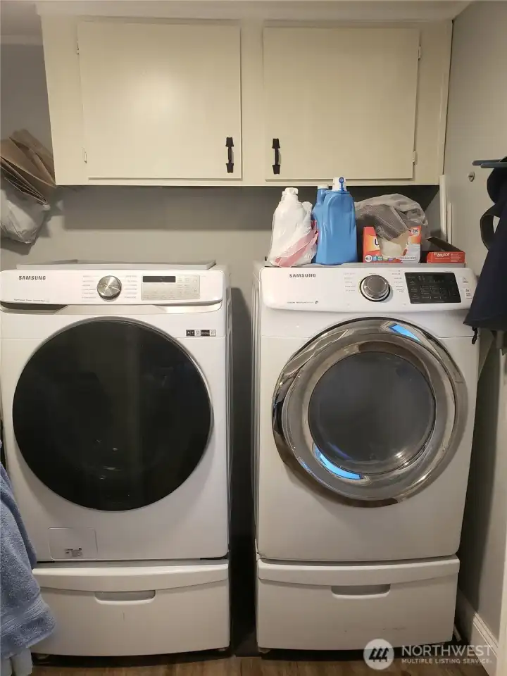 Utility Room with Upgraded Front Load Washer and Dryer that stay with the Home.