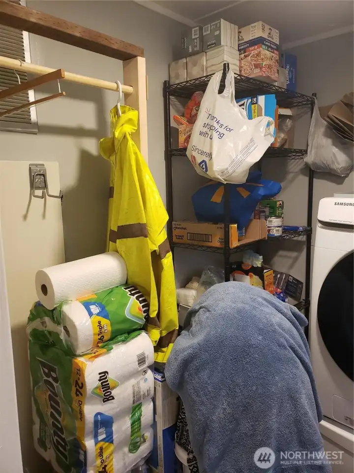 Utility Room with Upgraded Front Load Washer and Dryer and Shelves and Storage Area that stay with the Home.