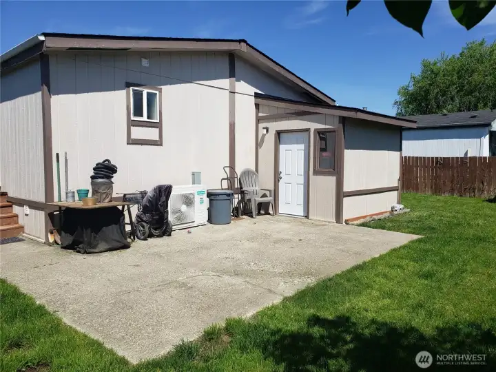 Spacious Pet Friendly Fully Fenced Backyard Showing HVAC AC Unit and Dry Storage Shed.