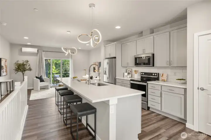 A spacious kitchen island with terrazzo-style quartz adds flexible workspace and plenty of room to gather. A spacious kitchen island with terrazzo-style quartz adds flexible workspace and plenty of room to gather.