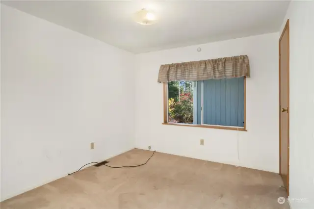 2nd bedroom, looking out to the carport.