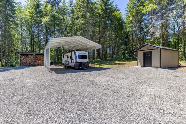 8’ x 16’ covered wood storage, separate from home sale  30’ x 24’ covered RV storage with 2 - 30-amp electrical plugs, water access and frost-free spigot   LOTS of parking in gravel driveway as well as big boy toy and RV parking areas   Individual well with 10’ x 20’ well shed complete with water softener and spin down filtration   system, storage area, heater and motion sensor security light.  10’ x 20’ shed with 60-amp electrical