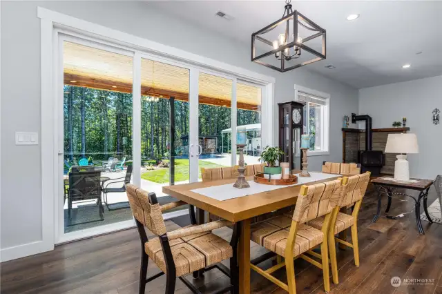 Dining Room with 8’ tall and 12’ wide double sliding glass doors lead to picturesque rear yard