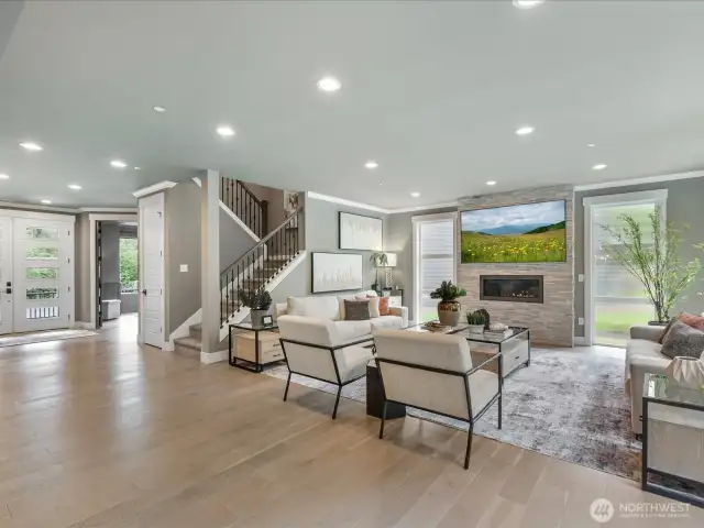 Open floorplan with floor to ceiling stone fireplace