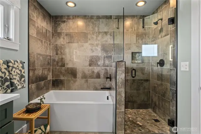 Soaking tub and custom tiled shower.