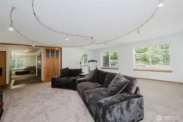 HUGE bonus room currently used as a theater room and an exercise space.  The opportunities for entertaining here are endless.  Custom Craftsman doors set on a sliding frame to allow for massive doorway to be completely opened to the rest of the house.