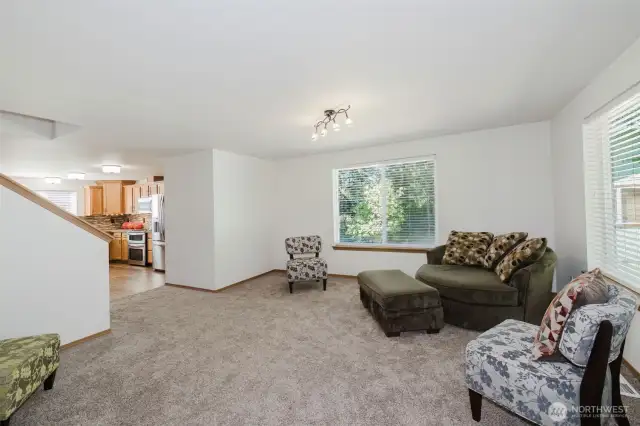 Looking on through the living room to the kitchen.  Home has a great natural, open flow floor plan.