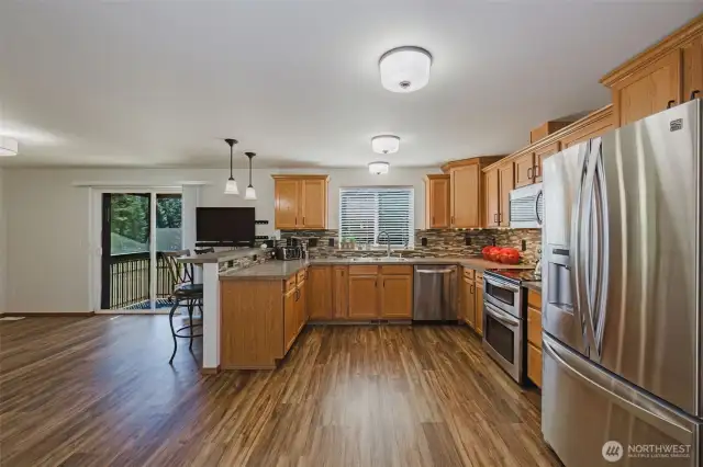 Generous kitchen with newer appliances and large eat-in space at the bar as well as a large space for a table.  Western facing window and door get flooded with light in the afternoon and evening.  Best view while doing the dishes is a good PNW sunset.