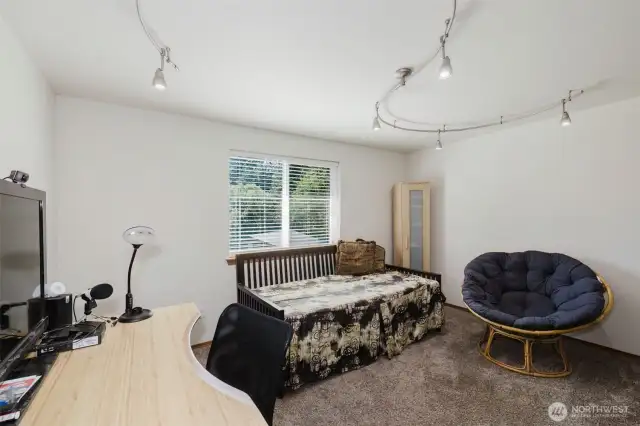 Third bedroom located upstairs with western facing window and a walk-in closet.