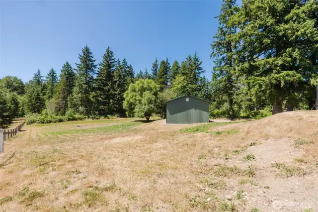 The property extends beyond the trees in the background.  Almost 5 acres!