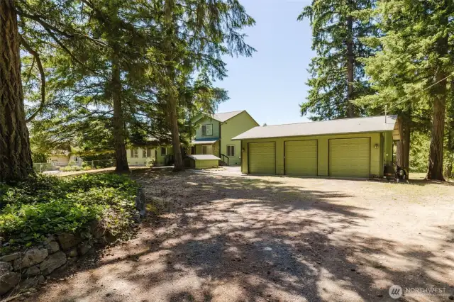 As you come in through the gate, the 3 car garage is the first thing you will see.  The house is to the left and the drive down to the shop is to the right.  Garage has 9ft doors so you can fit trucks easily!