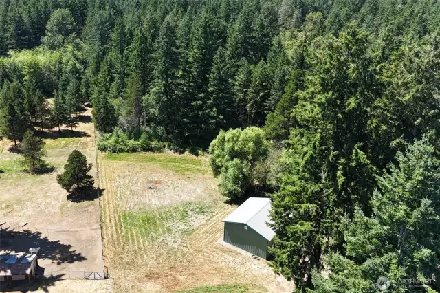 Property goes back into the trees and has a trail to the back.