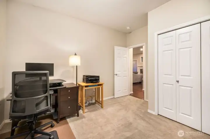 This main floor bedroom/den has an adjacent full bathroom