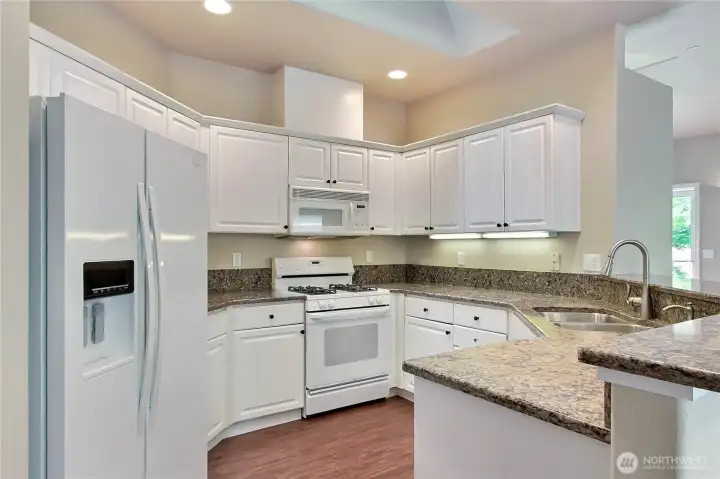 Granite counters throughout kitchen and bathrooms.