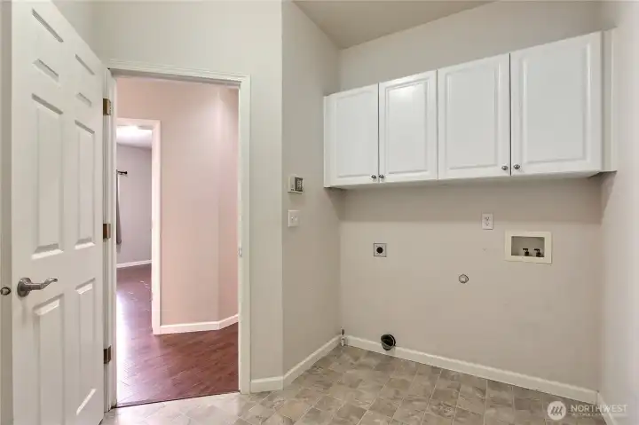 Laundry room with closet, leads to garage.