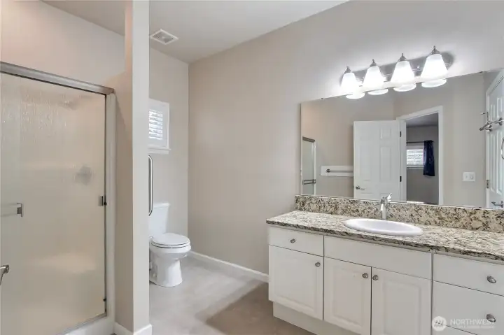 Primary bath with newer toilet and shower door.