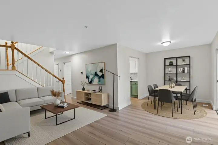 Open-concept living room with new flooring, large windows, and bright natural light in Everett townhome near I-5 and Park & Ride.Virtually Staged