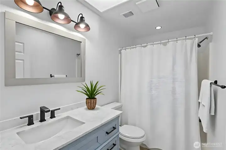 Full upper-level bathroom with updated fixtures in Everett townhome near amenities and I-5 access. virtually staged