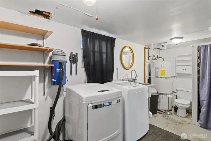 Large utility room with new washer and dryer units and 3/4 bath.
