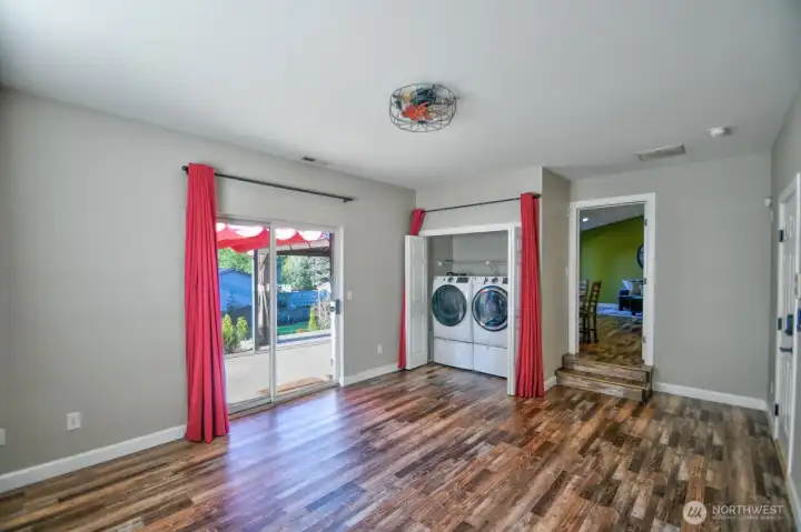 REC ROOM WITH WASHER DRYER, SLIDING DOOR OPEN TO BACK PATIO WITH GAZEBO AND HOT TUB