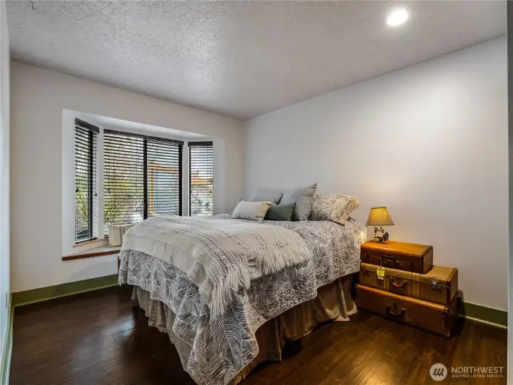 The guest bedroom #1, has a window seat and a bay window that allows light.