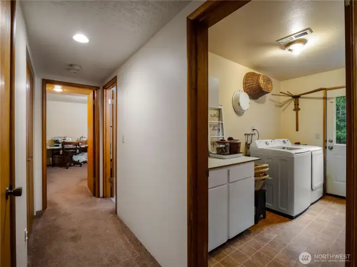 The laundry room has storage and an exit to the back yard.