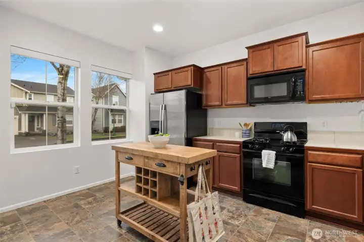 This kitchen cart stays with the home, and there is also plenty of room to add a permanent island, or additional dining table