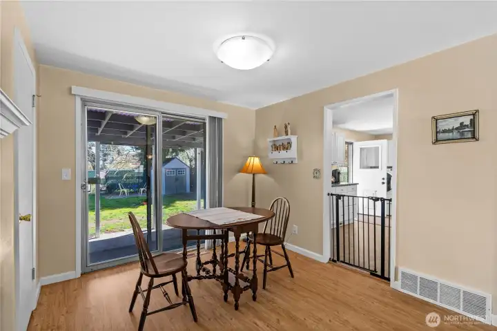The dining room area overlooks the covered patio and backyard.