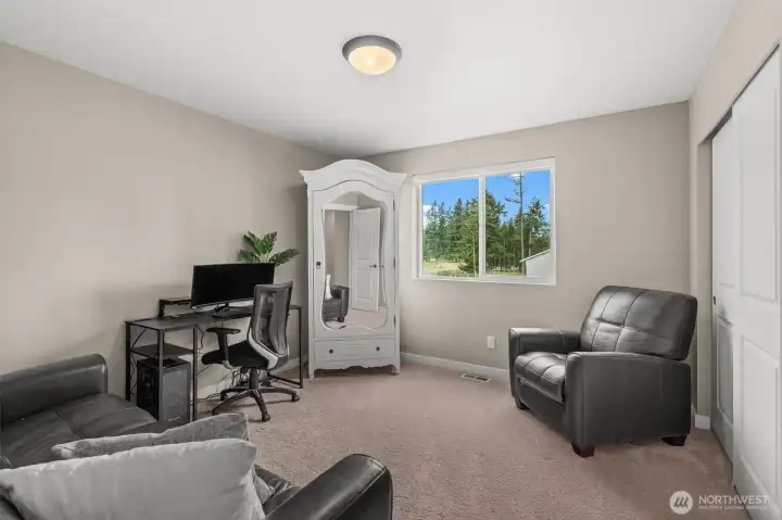 This secondary bedroom is currently curated as a sophisticated home office, illustrating the home’s adaptability to your lifestyle needs