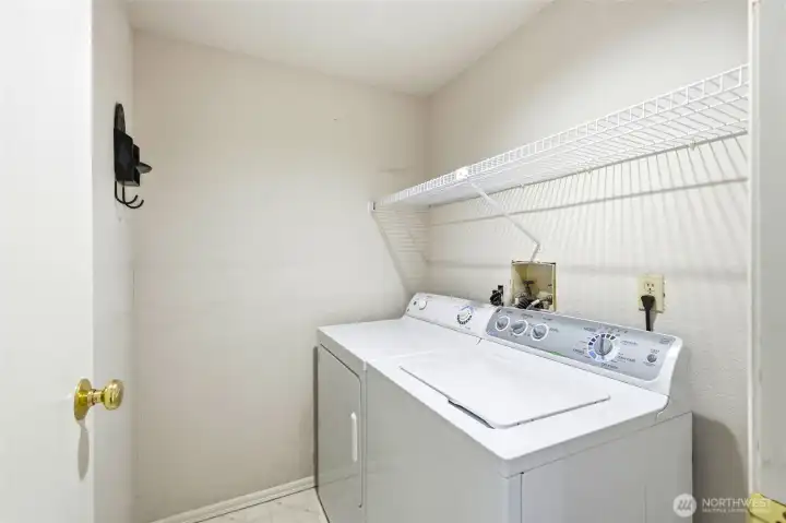 Convenient in-unit laundry area with storage space