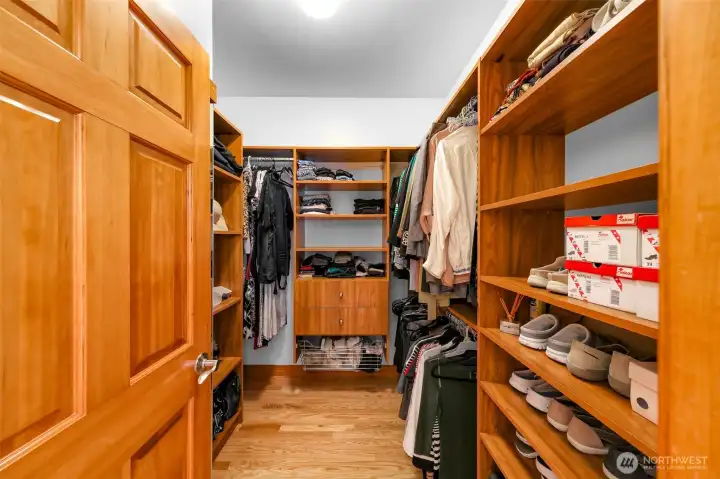 Primary Walk In Closet with custom organizers.