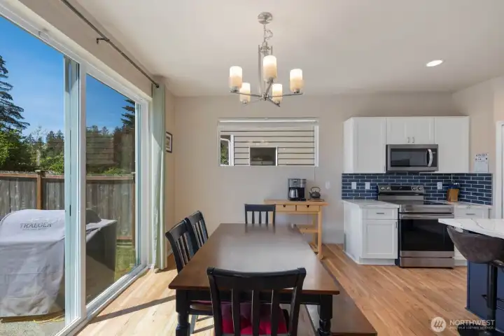 Kitchen with oversized island seating, stainless steel appliances, recessed lighting, and generous cabinet storage.
