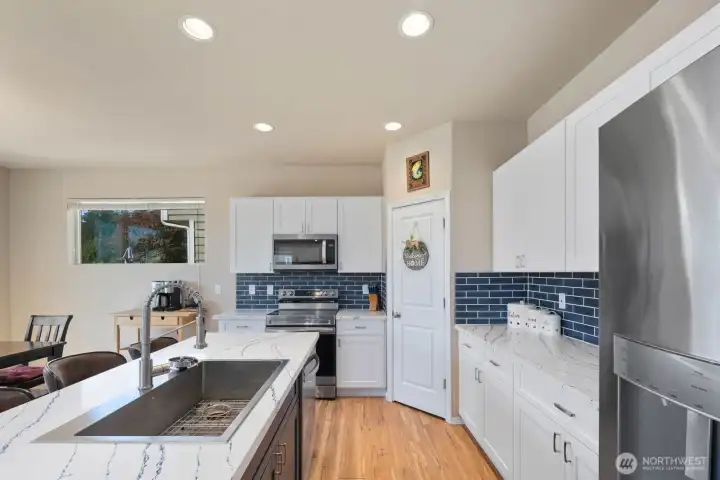 Additional kitchen view showcasing the open layout and connection to the dining and living areas.