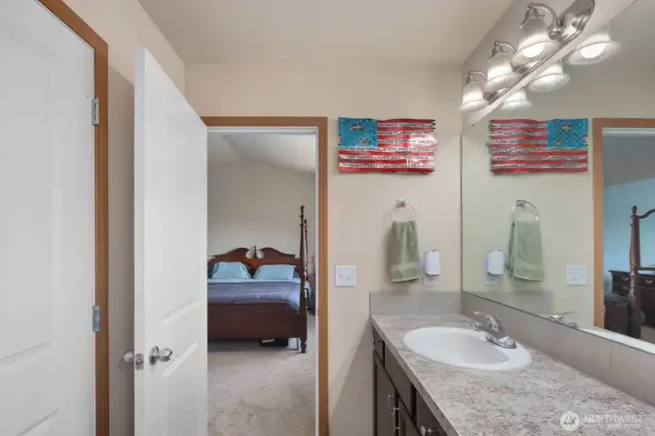 Secondary vanity area connected to the primary suite with additional storage and counter space.