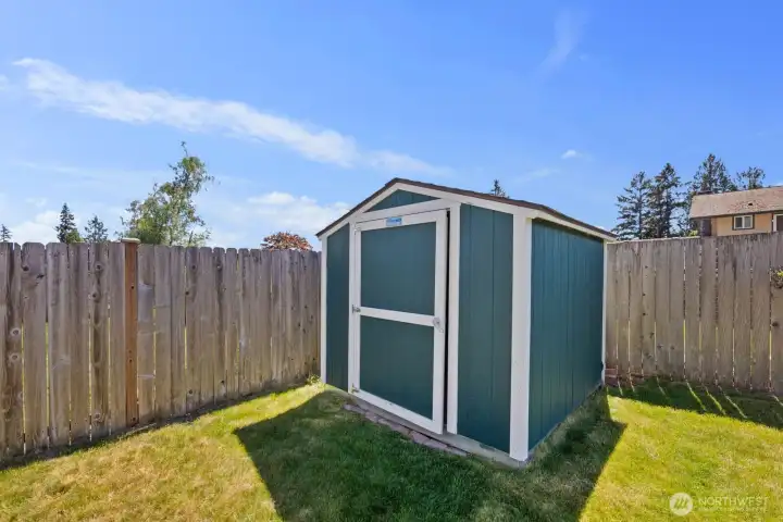 Storage shed offering additional space for tools, hobbies, or seasonal storage.