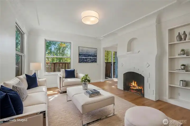 Formal living room with a wood burning fireplace. Lovely built in shelving.