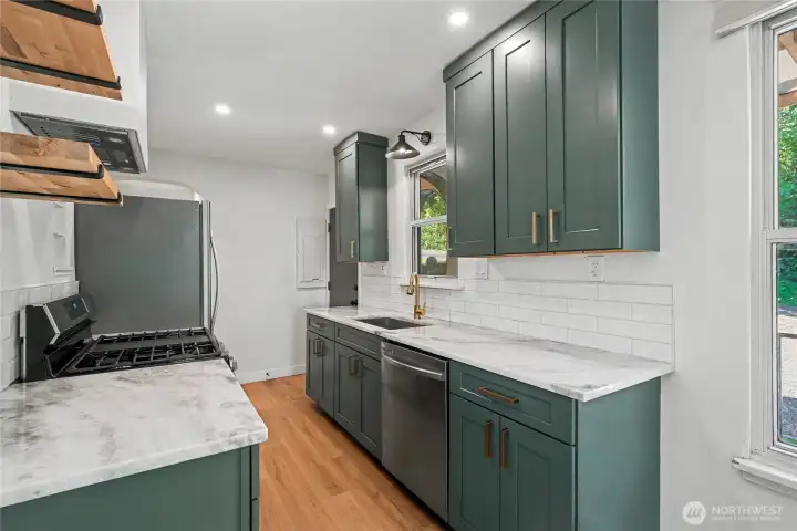 Kitchen has been tastefully remodeled with quartz counters, new cabinetry and stainless appliances.