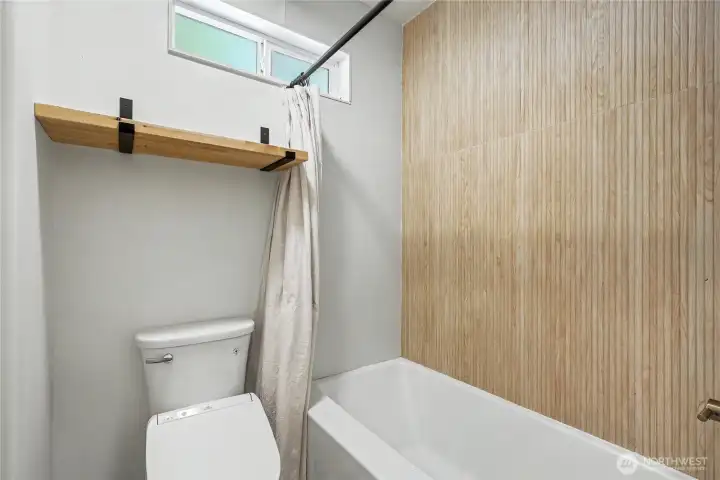 Bath/shower in main level bathroom, which has been completely remodeled.