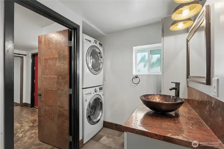 Three quarter bath/laundry area on lower level.