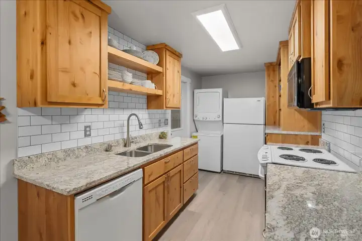 Beautifully updated, this kitchen features stunning quartz countertops and sleek modern finishes. Beautifully updated, this kitchen features stunning quartz countertops and sleek modern finishes.