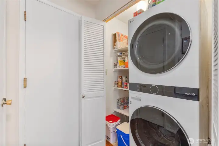 Pantry/washer dryer behind bifold doors in kitchen.