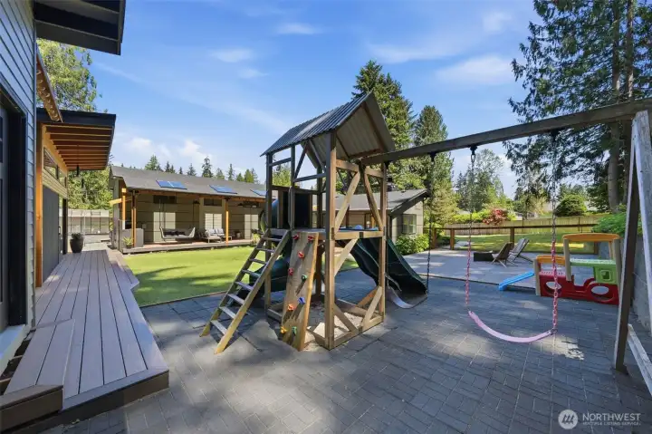 Dedicated playground area within the fenced backyard.