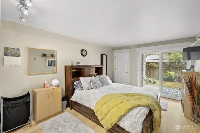Very spacious bedroom has sliding door to the backyard.  Original outside storage has been converted to a storage closet accessible from the inside.